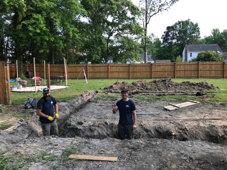 Owners Chris and Seth from BNH Builders working on a home foundation